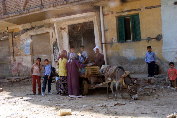 Children and adults outside a building, Egypt