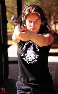 Lætitia Casta taking aim with a revolver.