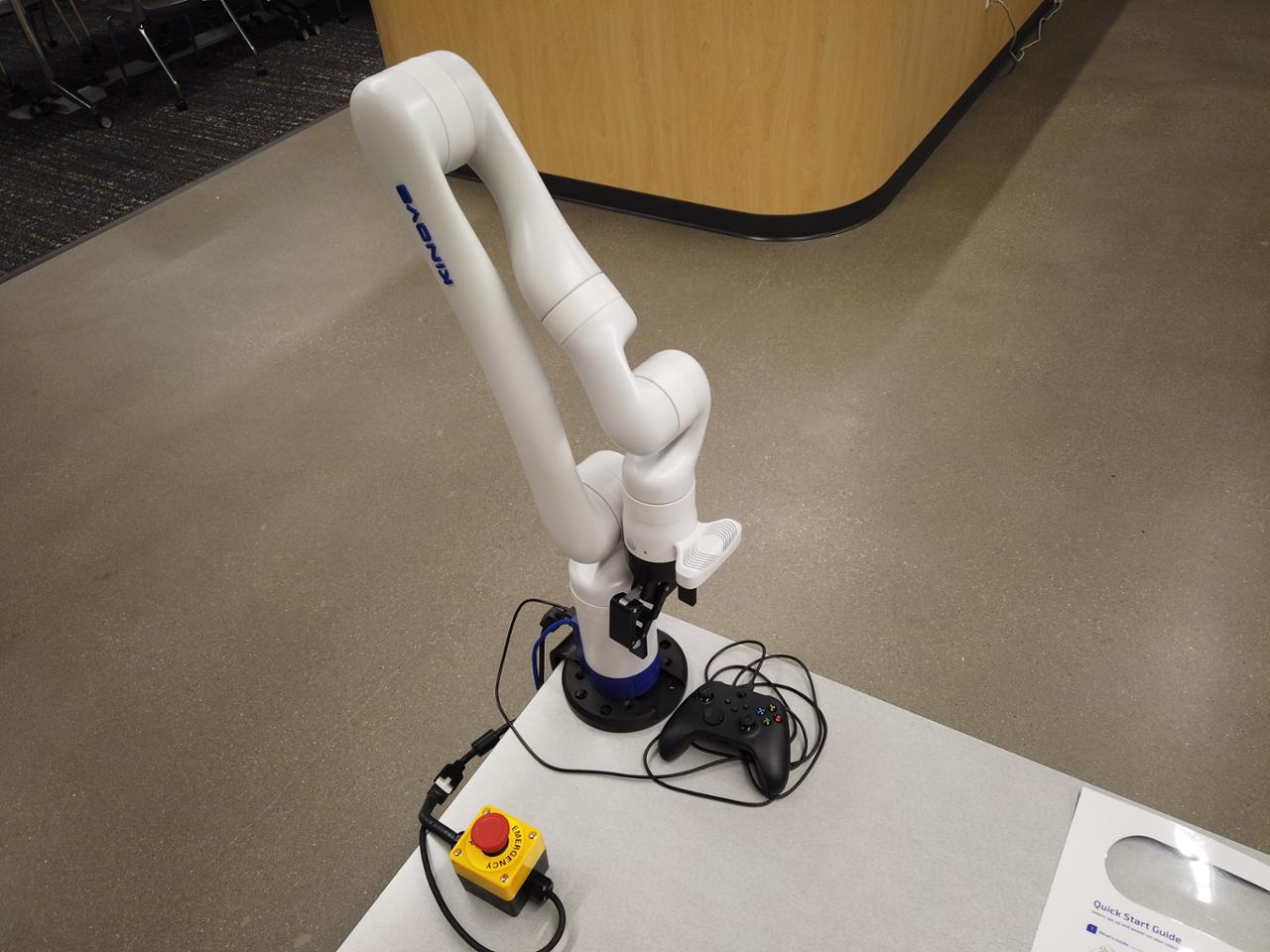 A lightweight robot arm, gamepad, and emergency stop button