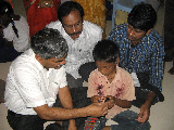 Andhra Pradesh government officials observing how a child learns using one of the lab's educational software on a cellphone