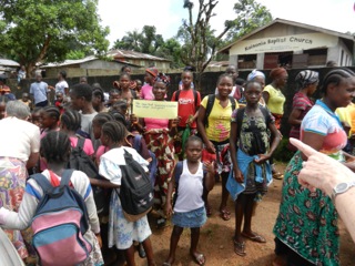 Children and adults in the town square, Liberia