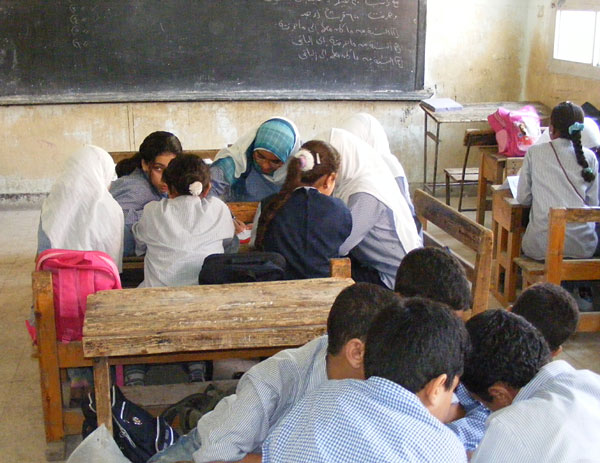 Children working at small tables in their classroom, Egypt