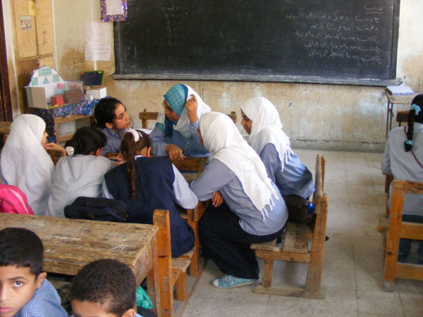 Children working at small tables in their classroom, Egypt