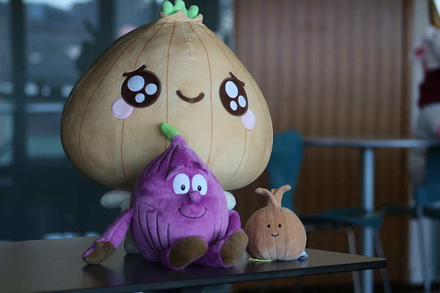 Three stuffed onions of varying size and expression.