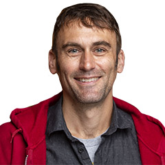 Jeffrey P. Bigham, smiling wearing a red hoodie