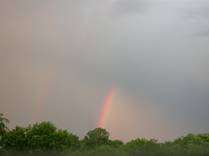 Primary and secondary rainbow, truncated by clouds.