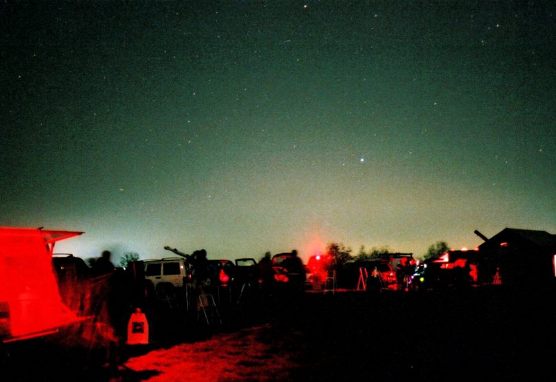 AAAP star party at Wagman Observatory. The brightest rising star is Vega (alpha Lyrae).  Light pollution is evident along the north horizon.  2001/4/27 21:54 EDT 30 second exposure on a tripod.  35mm lens f/2.8.  Fuji 800 negative film.